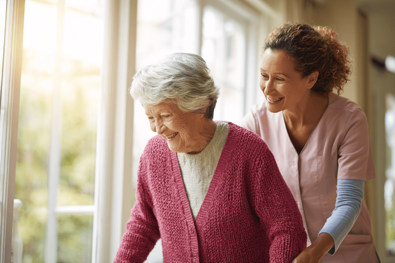 Caregiver_helping_senior_at_home_during_daytime_large_windows_87adc767-62fb-4881-8093-41ea76f99e69_0